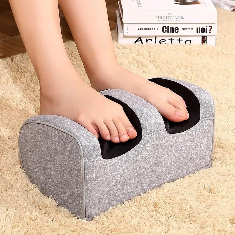 Trending Height electric foot massager in gray with feet placed inside on a beige carpet
