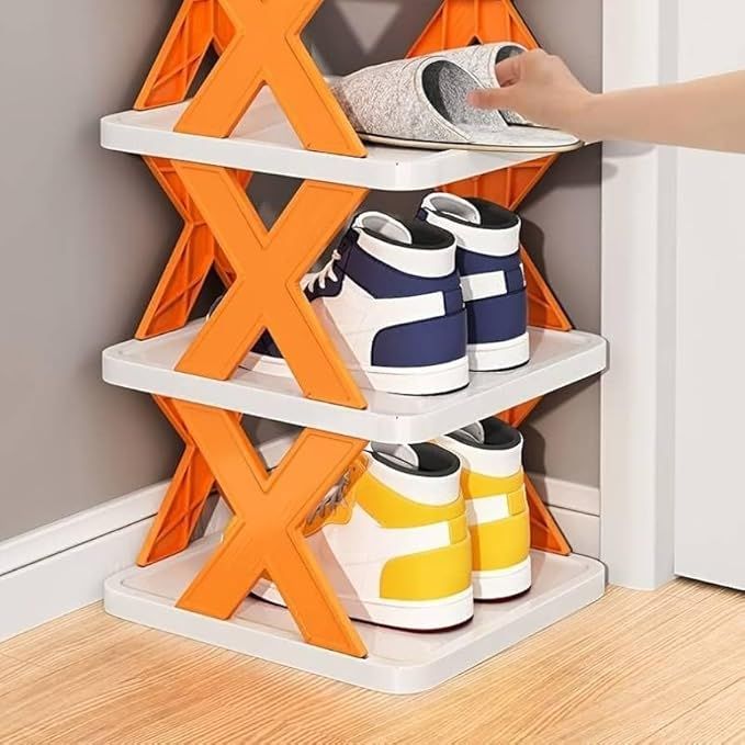 TRENDING HEIGHT orange and white x shaped shoe rack holding multiple pairs of shoes with a hand placing slippers